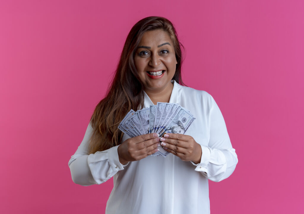 FAQ'S Smiling Casual Caucasian Middle Aged Woman Holding Cash Pink 1024x721